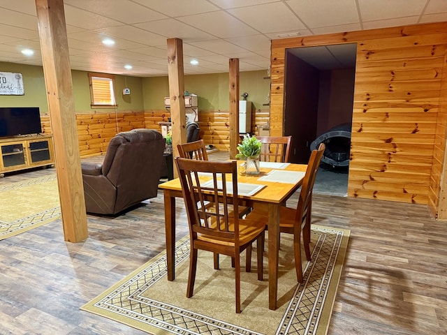dining area featuring wood walls, a wainscoted wall, wood finished floors, and recessed lighting