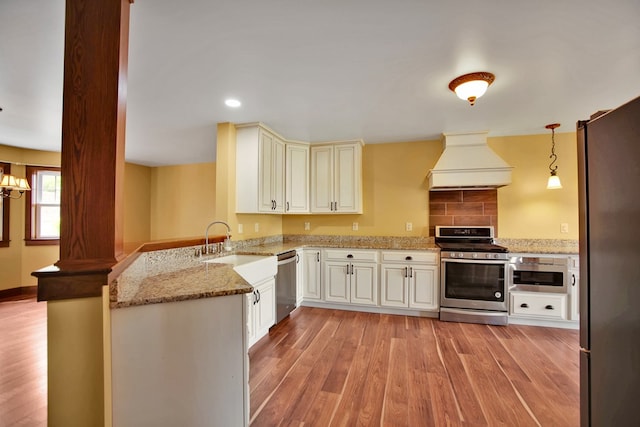 77 Hunters Trl, Wellsboro, PA 16901 - kitchen with appliances with stainless steel finishes, custom exhaust hood, a peninsula, light wood-type flooring, and light stone countertops