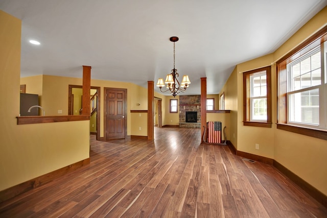 77 Hunters Trl, Wellsboro, PA 16901 - unfurnished living room with dark wood-style floors, baseboards, a stone fireplace, recessed lighting, and a chandelier