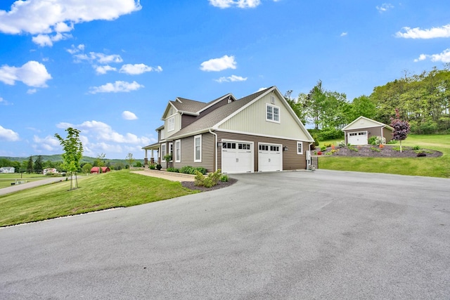 77 Hunters Trl, Wellsboro, PA 16901 - view of front facade with a front yard, asphalt driveway, and an attached garage