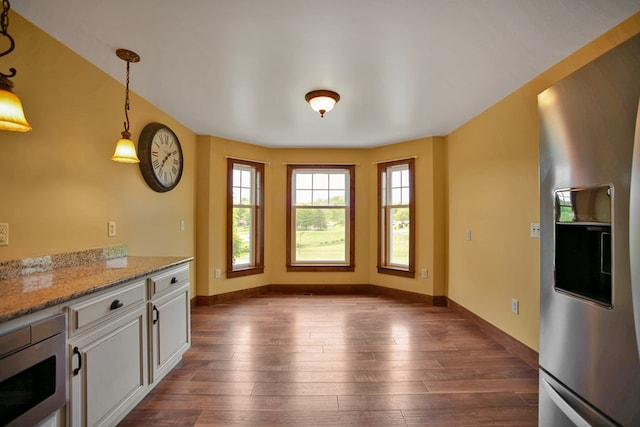 77 Hunters Trl, Wellsboro, PA 16901 - kitchen with stainless steel appliances, dark wood-style floors, decorative light fixtures, white cabinetry, and baseboards