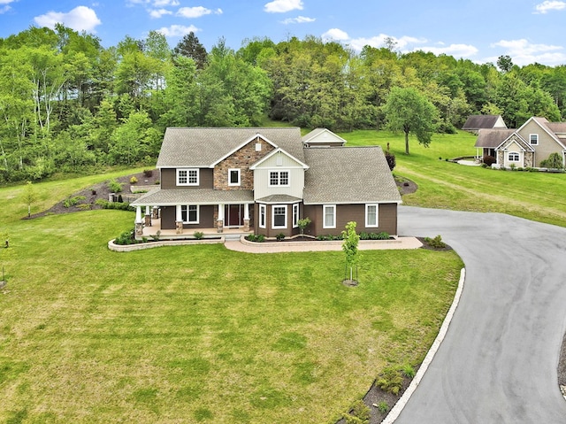 77 Hunters Trl, Wellsboro, PA 16901 - view of front of house with a porch, a shingled roof, a front lawn, and asphalt driveway