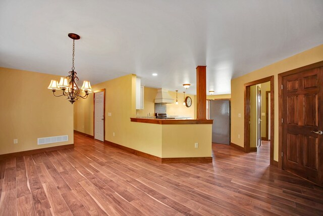 77 Hunters Trl, Wellsboro, PA 16901 - unfurnished living room with a chandelier, wood finished floors, baseboards, and recessed lighting