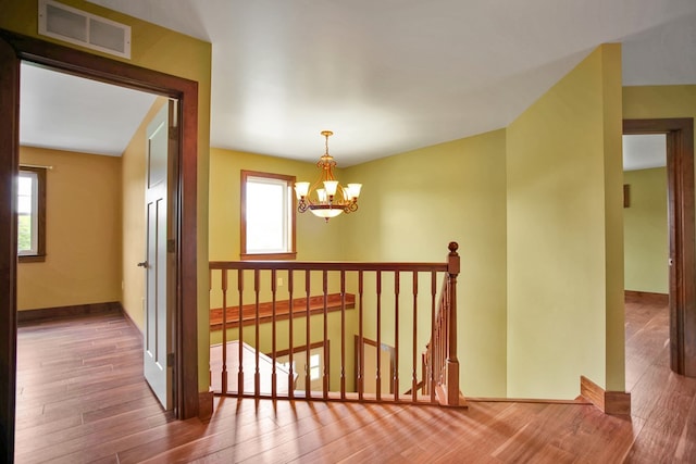 77 Hunters Trl, Wellsboro, PA 16901 - corridor featuring wood finished floors, a chandelier, baseboards, and an upstairs landing