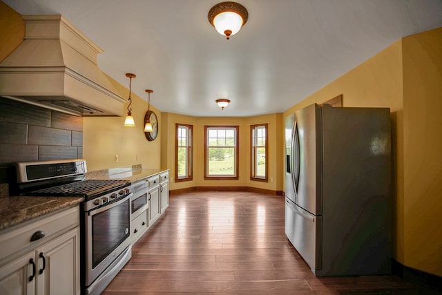 77 Hunters Trl, Wellsboro, PA 16901 - kitchen featuring appliances with stainless steel finishes, premium range hood, decorative backsplash, dark wood-type flooring, and decorative light fixtures