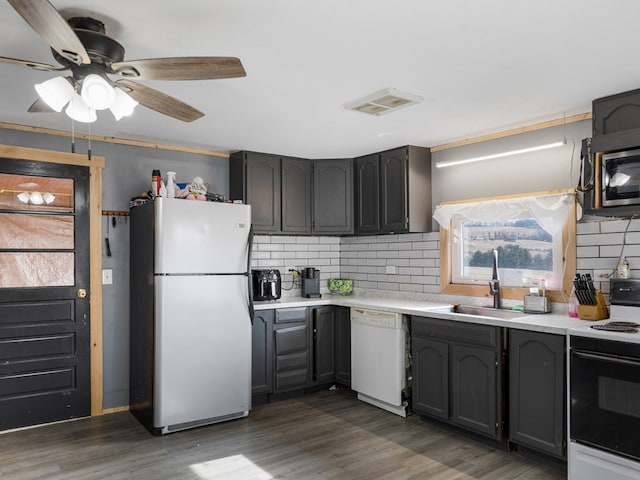 kitchen featuring range with electric cooktop, refrigerator, sink, dark hardwood / wood-style flooring, and white dishwasher