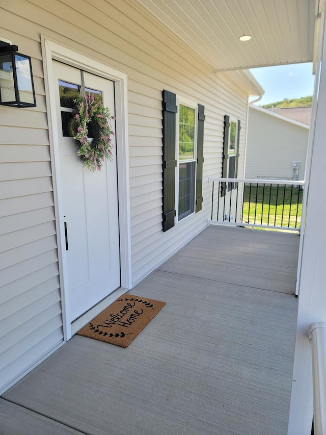 view of exterior entry with covered porch