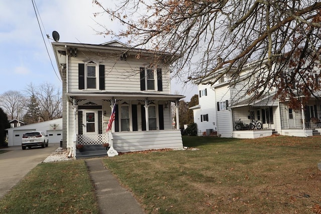 italianate home featuring a garage, an outdoor structure, and a front lawn