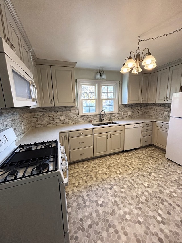 kitchen featuring white appliances, sink, hanging light fixtures, gray cabinets, and a chandelier