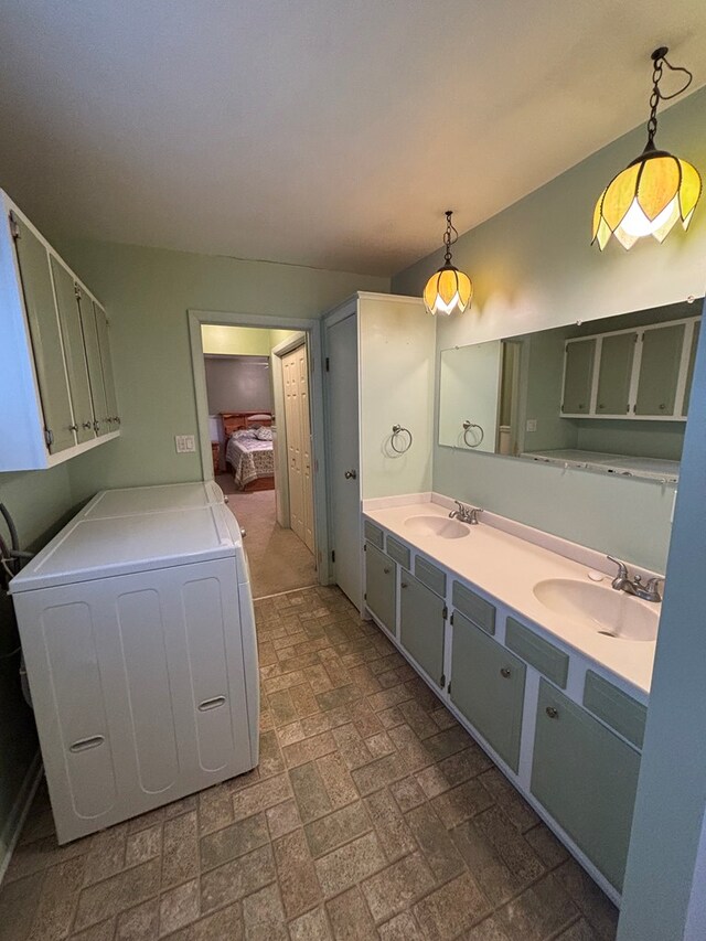 bathroom with vanity and washer / dryer