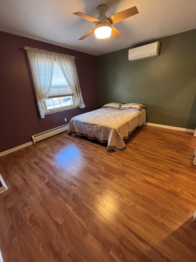 bedroom with a wall mounted air conditioner, ceiling fan, hardwood / wood-style flooring, and a baseboard heating unit