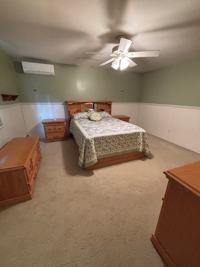 bedroom featuring carpet, ceiling fan, and an AC wall unit