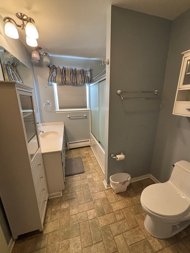 full bathroom featuring shower / bath combination with glass door, vanity, a baseboard radiator, and toilet