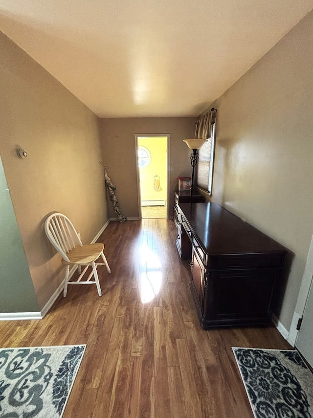 interior space featuring dark hardwood / wood-style flooring and a baseboard heating unit