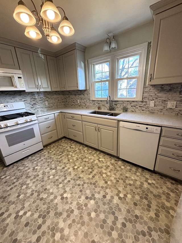 kitchen with sink, a chandelier, decorative light fixtures, white appliances, and gray cabinets