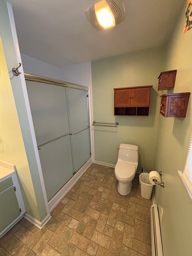 bathroom with vanity, a baseboard radiator, toilet, and an enclosed shower