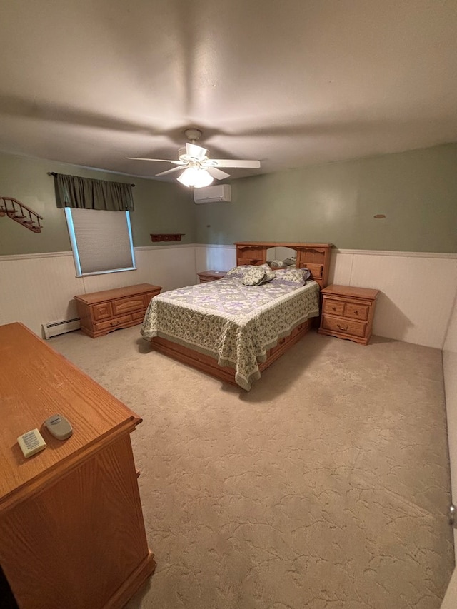 carpeted bedroom with a wall mounted air conditioner, ceiling fan, wooden walls, and a baseboard radiator