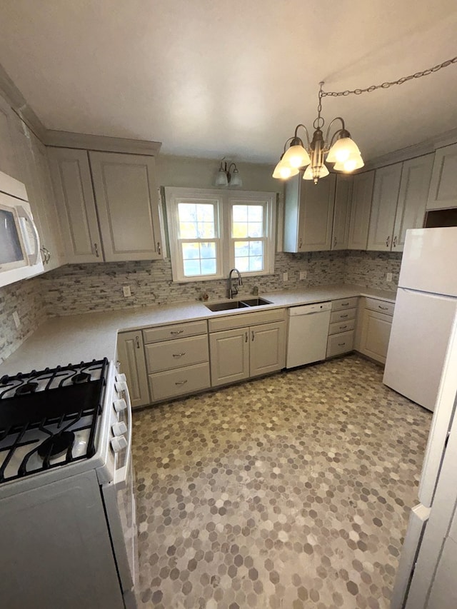 kitchen featuring white appliances, sink, decorative light fixtures, decorative backsplash, and a notable chandelier