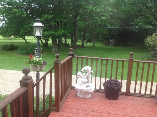 wooden terrace with a lawn