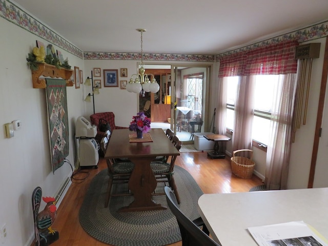 dining area featuring a chandelier and hardwood / wood-style flooring