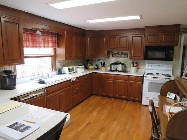 kitchen featuring stainless steel gas cooktop, sink, dishwasher, white electric range, and light hardwood / wood-style floors