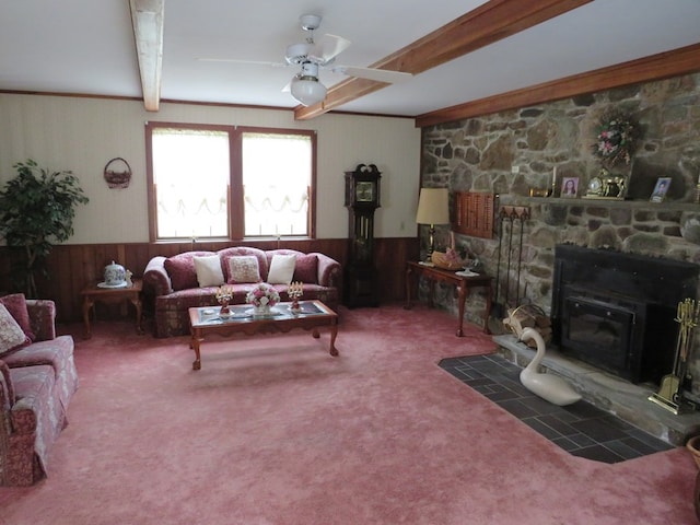 living room featuring beam ceiling, ceiling fan, dark carpet, and wood walls