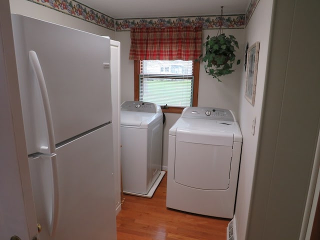 washroom featuring separate washer and dryer and light wood-type flooring