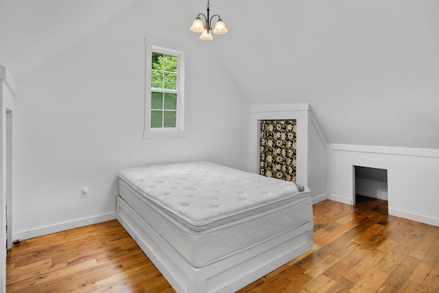 511 Steam Mill Rd, Wellsboro, PA 16901 - bedroom featuring vaulted ceiling, a chandelier, light wood-style flooring, and baseboards