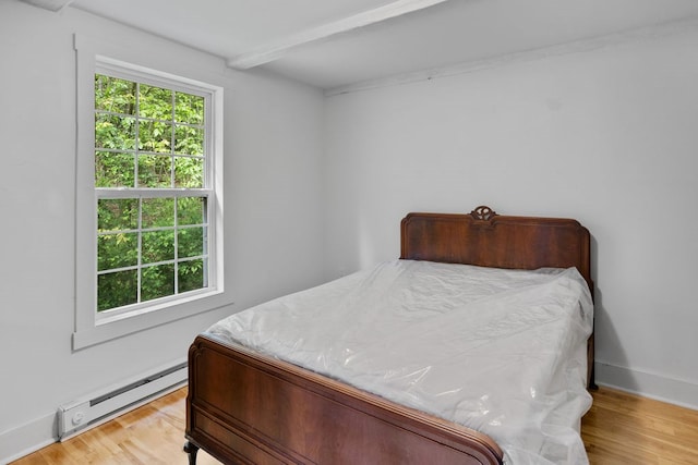 511 Steam Mill Rd, Wellsboro, PA 16901 - bedroom featuring a baseboard radiator, wood finished floors, beamed ceiling, and baseboards