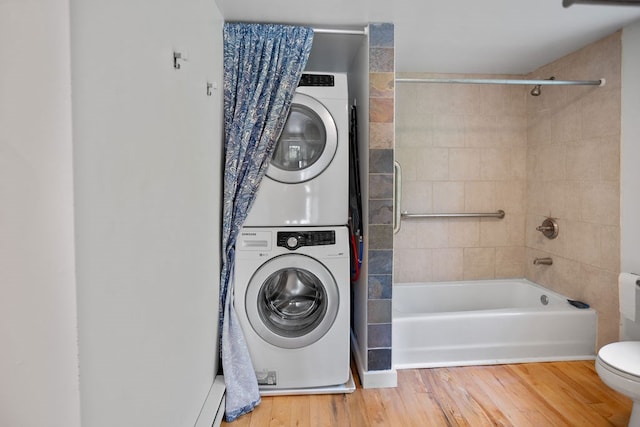 511 Steam Mill Rd, Wellsboro, PA 16901 - laundry room featuring stacked washer / drying machine and wood finished floors