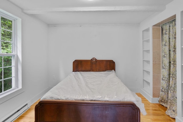511 Steam Mill Rd, Wellsboro, PA 16901 - bedroom with a baseboard heating unit, beamed ceiling, multiple windows, and light wood-style floors