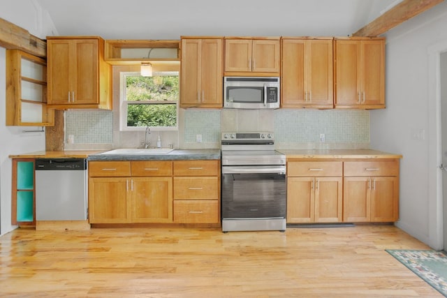 511 Steam Mill Rd, Wellsboro, PA 16901 - kitchen featuring appliances with stainless steel finishes, a sink, open shelves, light wood-style flooring, and vaulted ceiling