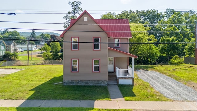 view of front of home with a porch and a front yard