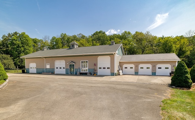 garage featuring view of wooded area