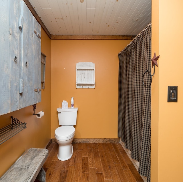 bathroom with wood finished floors, toilet, wood ceiling, curtained shower, and crown molding