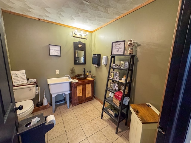 bathroom featuring vanity, ornamental molding, tile patterned flooring, and toilet