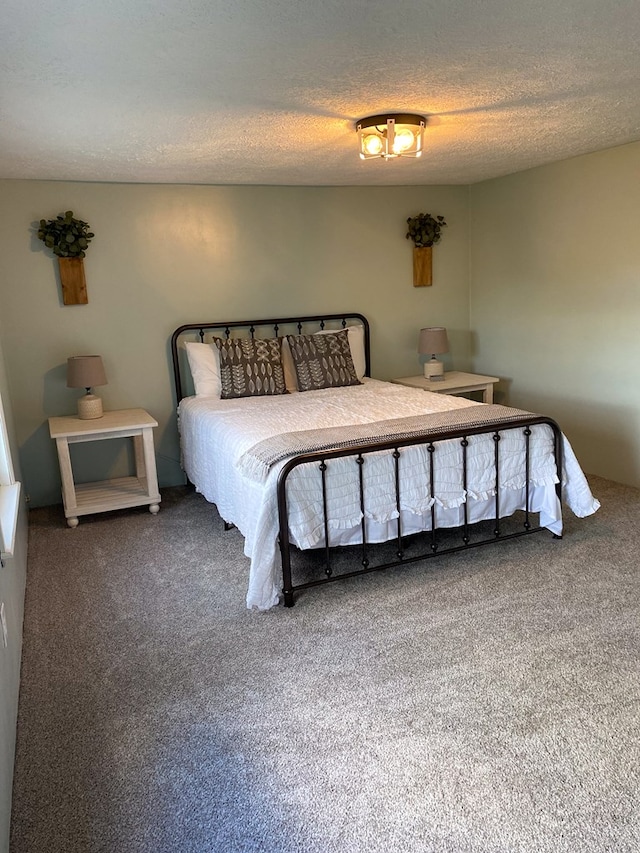 bedroom featuring a textured ceiling and carpet floors