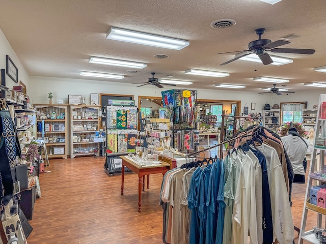 miscellaneous room featuring visible vents, a textured ceiling, and wood finished floors