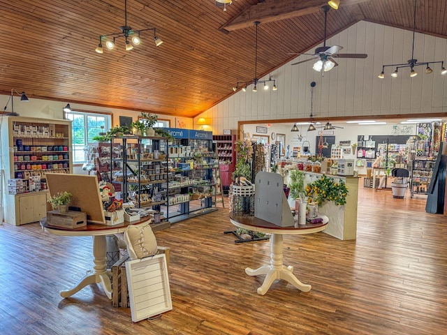 misc room featuring a ceiling fan, wood ceiling, wood finished floors, wood walls, and high vaulted ceiling