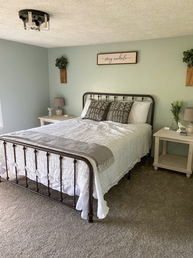 bedroom with carpet flooring and a textured ceiling