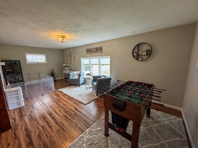 playroom with hardwood / wood-style floors and a textured ceiling