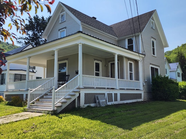 406 E Maple St, Coudersport, PA 16915 - farmhouse-style home with a front lawn, a porch, and a shingled roof