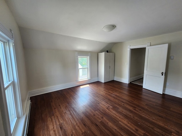 406 E Maple St, Coudersport, PA 16915 - unfurnished bedroom featuring lofted ceiling, dark wood-style flooring, and a baseboard radiator
