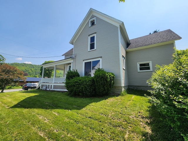 406 E Maple St, Coudersport, PA 16915 - rear view of house featuring roof with shingles, a lawn, and covered porch