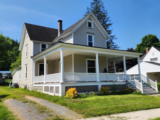 406 E Maple St, Coudersport, PA 16915 - farmhouse-style home featuring covered porch, a chimney, and a front lawn
