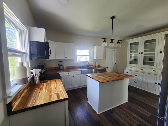 406 E Maple St, Coudersport, PA 16915 - kitchen featuring butcher block counters, black microwave, range, dark wood-style flooring, and white cabinets