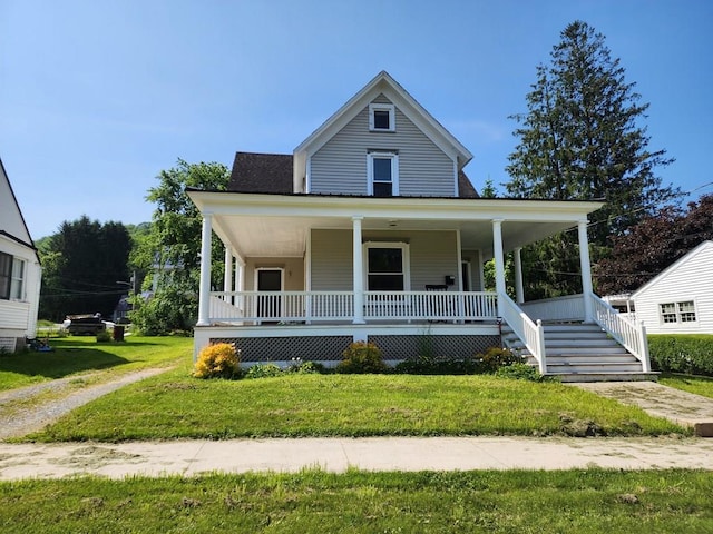 406 E Maple St, Coudersport, PA 16915 - farmhouse-style home with a porch, a front yard, and stairway