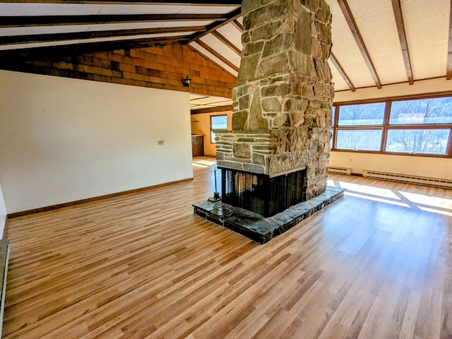 unfurnished living room featuring a fireplace, wood finished floors, high vaulted ceiling, beamed ceiling, and baseboards