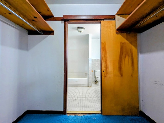 spacious closet featuring tile patterned flooring