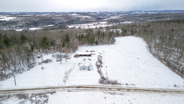 snowy aerial view featuring a mountain view